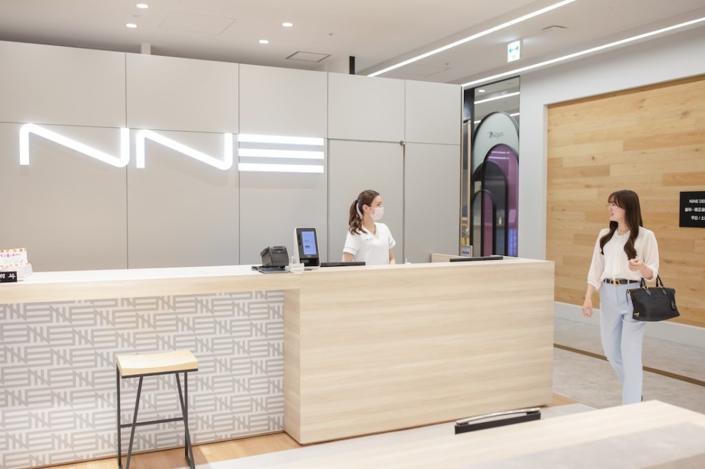 NINE DENTAL 心斎橋PARCOの受付に向かう20代女性